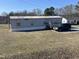 Single-story home featuring a front porch, siding, and car in the driveway at 2113 Nc 55, Coats, NC 27521