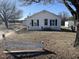 Exterior view of white cottage with new siding, shed, and partial white fence at 2113 Nc 55, Coats, NC 27521