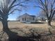 Charming home with a gabled roof, front porch, and mature trees in the front yard at 2113 Nc 55, Coats, NC 27521
