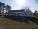 Inviting single-story home featuring a charming front porch and well-maintained landscaping at 2113 Nc 55, Coats, NC 27521