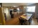 This eat-in kitchen features wood floors, a breakfast bar, stainless steel appliances, and a dining area at 2113 Nc 55, Coats, NC 27521