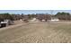 Expansive land showcasing a farmhouse and agricultural potential with a white fence at 2113 Nc 55, Coats, NC 27521