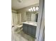 Bathroom featuring tub/shower, a double sink vanity, and marble tile floor at 2114 Stoney Spring Dr, Raleigh, NC 27610