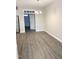Dining room with chandelier and view of entry with wood-look flooring and neutral paint at 2114 Stoney Spring Dr, Raleigh, NC 27610