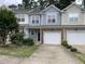 Charming townhome featuring a one car garage, complemented by tasteful landscaping and curb appeal at 2114 Stoney Spring Dr, Raleigh, NC 27610