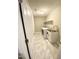 A laundry room featuring marble tile floors, a sink, washer and dryer hookups, and shelving at 2114 Stoney Spring Dr, Raleigh, NC 27610