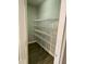 Walk-in pantry features wood-look floors and multiple wire rack shelves for storage at 2114 Stoney Spring Dr, Raleigh, NC 27610