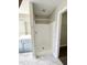 Bathroom with shower, blue vanity with double sinks, and marble tile floor at 2114 Stoney Spring Dr, Raleigh, NC 27610
