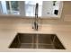 Stainless steel sink with industrial style pull-down faucet and white quartz countertops at 2114 Stoney Spring Dr, Raleigh, NC 27610