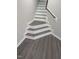 Staircase with wood-look stairs, white risers, and white painted trim at 2114 Stoney Spring Dr, Raleigh, NC 27610