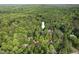Aerial view of home nestled amongst mature trees on a private lot at 216 Copper Beech Ct, Chapel Hill, NC 27517