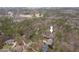 This aerial view shows a wooded property with a large home and lush landscaping at 216 Copper Beech Ct, Chapel Hill, NC 27517