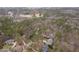 This aerial view shows a wooded property with a large home and lush landscaping at 216 Copper Beech Ct, Chapel Hill, NC 27517