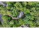 Aerial view of home nestled amongst mature trees on a private lot at 216 Copper Beech Ct, Chapel Hill, NC 27517