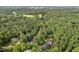 Aerial view of home nestled amongst mature trees in a planned community at 216 Copper Beech Ct, Chapel Hill, NC 27517
