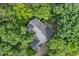 Aerial view of home featuring a gray roof surrounded by mature trees at 216 Copper Beech Ct, Chapel Hill, NC 27517