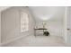 Carpeted attic room with a window and desk, perfect for a home office or extra storage at 216 Copper Beech Ct, Chapel Hill, NC 27517