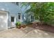 Back of house with an entrance, brick walkway, established landscape and mature trees at 216 Copper Beech Ct, Chapel Hill, NC 27517