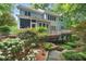 Expansive backyard featuring a multi-tiered deck, lush landscaping, and mature trees providing ample privacy at 216 Copper Beech Ct, Chapel Hill, NC 27517