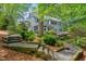 Backyard featuring a well-maintained yard, mature trees, and deck at 216 Copper Beech Ct, Chapel Hill, NC 27517