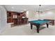 Finished basement featuring a bar with seating and a pool table for entertainment at 216 Copper Beech Ct, Chapel Hill, NC 27517