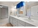Well-lit bathroom with a double sink vanity, bright window and adjacent bedroom access at 216 Copper Beech Ct, Chapel Hill, NC 27517