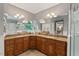 Spacious bathroom with a double vanity, granite countertops, and decorative mirrors, offering a luxurious feel at 216 Copper Beech Ct, Chapel Hill, NC 27517