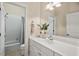 Well-lit bathroom with a vanity, white countertop, and combination shower and tub at 216 Copper Beech Ct, Chapel Hill, NC 27517