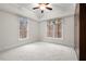 Neutral bedroom featuring large windows for natural light and a ceiling fan for comfort at 216 Copper Beech Ct, Chapel Hill, NC 27517