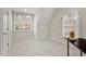 Cozy bedroom with neutral carpet, two windows, and a side table at 216 Copper Beech Ct, Chapel Hill, NC 27517