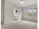 Bright bedroom with neutral carpet, three large windows, and an ensuite bathroom at 216 Copper Beech Ct, Chapel Hill, NC 27517