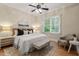 Cozy bedroom featuring a comfortable bed, stylish decor, and natural light from a large window at 216 Copper Beech Ct, Chapel Hill, NC 27517
