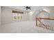Large bonus room with neutral carpet, lots of light, ceiling fan and staircase access at 216 Copper Beech Ct, Chapel Hill, NC 27517