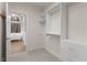 Bright walk-in closet leading to a luxurious bathroom with a soaking tub and natural light at 216 Copper Beech Ct, Chapel Hill, NC 27517