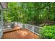 Relaxing outdoor deck space with comfortable seating and serene views of the surrounding wooded area at 216 Copper Beech Ct, Chapel Hill, NC 27517