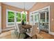 Elegant dining area with large windows, neutral paint, and access to the screened in porch makes for easy entertaining at 216 Copper Beech Ct, Chapel Hill, NC 27517