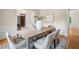 Dining room with wainscoting and a dining table and six chairs, with access to the living room and office at 216 Copper Beech Ct, Chapel Hill, NC 27517