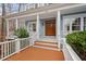 Charming front porch with stately columns and detailed trim, inviting guests into the home at 216 Copper Beech Ct, Chapel Hill, NC 27517