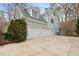 An attached two-car garage is nestled on the side of this charming light blue home at 216 Copper Beech Ct, Chapel Hill, NC 27517