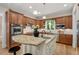 Well-appointed kitchen featuring granite countertops, custom cabinets, stainless appliances, and a functional center island with seating at 216 Copper Beech Ct, Chapel Hill, NC 27517
