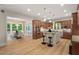 Gourmet kitchen with stainless appliances, island with seating, and an adjacent dining area filled with natural light at 216 Copper Beech Ct, Chapel Hill, NC 27517
