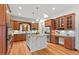 Spacious kitchen features granite countertops, wood cabinets, stainless steel appliances, and a central island at 216 Copper Beech Ct, Chapel Hill, NC 27517