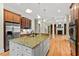 Open kitchen with granite countertops, center island, stainless appliances, and views to living room at 216 Copper Beech Ct, Chapel Hill, NC 27517