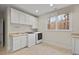 Modern laundry room with built-in sink, cabinets, and front-loading washer and dryer at 216 Copper Beech Ct, Chapel Hill, NC 27517