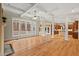 Expansive living area with hardwood floors, coffered ceilings, and views into the kitchen and screened porch at 216 Copper Beech Ct, Chapel Hill, NC 27517