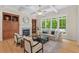 Bright living room with built-in cabinets, a fireplace, and floor-to-ceiling windows at 216 Copper Beech Ct, Chapel Hill, NC 27517
