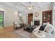 Spacious living room features hardwood floors, fireplace, custom built-ins, and coffered ceilings, ideal for relaxing and entertaining at 216 Copper Beech Ct, Chapel Hill, NC 27517