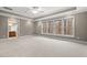 Spacious bedroom boasts tray ceilings, plush carpeting, and generous natural light from a large window at 216 Copper Beech Ct, Chapel Hill, NC 27517