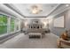 Elegant main bedroom featuring a tray ceiling, large windows, and sophisticated decor, creating a peaceful ambiance at 216 Copper Beech Ct, Chapel Hill, NC 27517