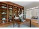 Office area with custom wood built-ins, a work desk, and natural light, creating a professional setting at 216 Copper Beech Ct, Chapel Hill, NC 27517